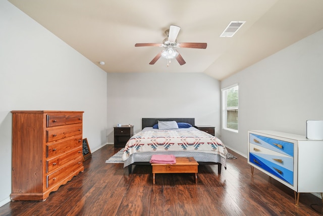 bedroom with baseboards, wood finished floors, and visible vents