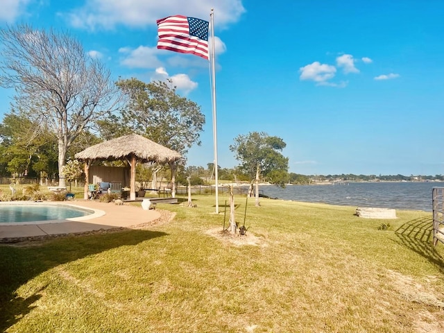 view of home's community with a gazebo, a water view, a yard, and a pool
