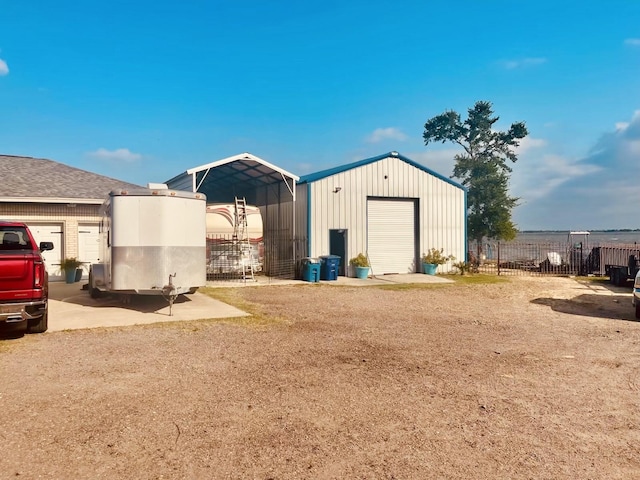 view of outbuilding featuring fence and an outbuilding
