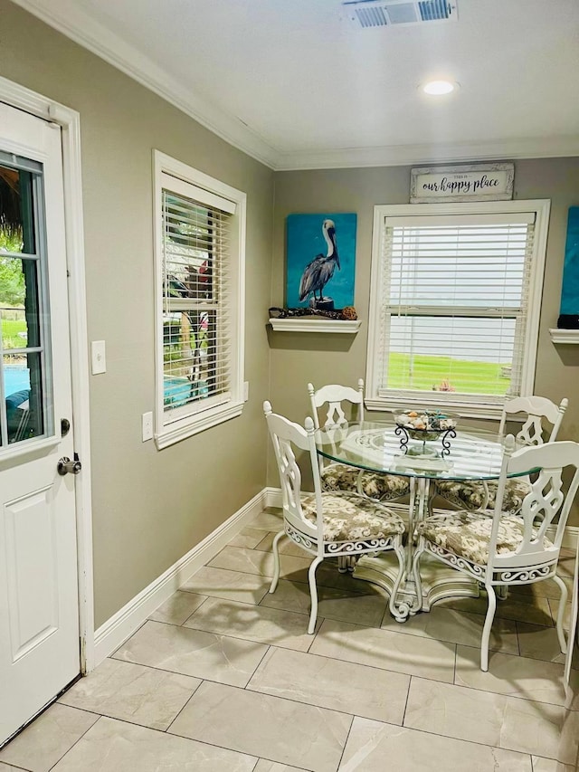 dining room featuring ornamental molding, healthy amount of natural light, baseboards, and recessed lighting