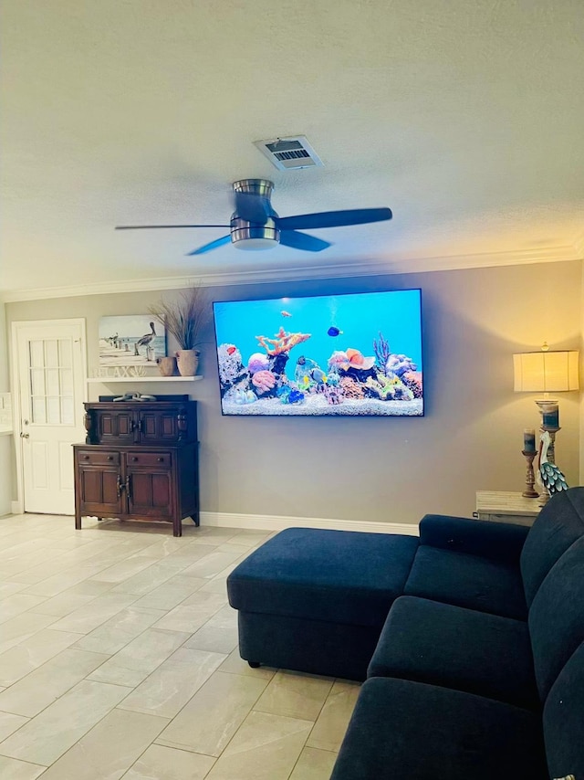 living room featuring ornamental molding, ceiling fan, and baseboards