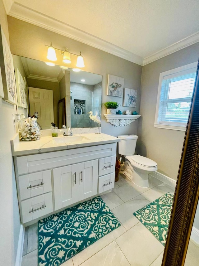 full bathroom featuring ornamental molding, toilet, vanity, baseboards, and tile patterned floors