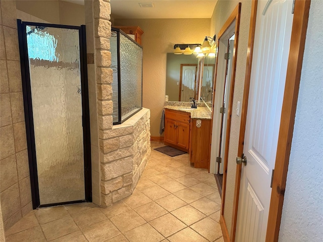 15395 Kitty Hawk Dr, Waller, TX 77484 - full bathroom with a textured wall, vanity, tile patterned flooring, and a stall shower