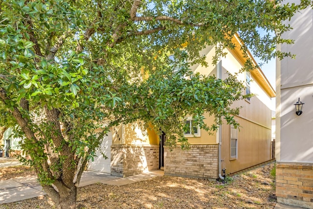 4934 S Cancun Dr, Houston, TX 77045 - view of side of home featuring brick siding