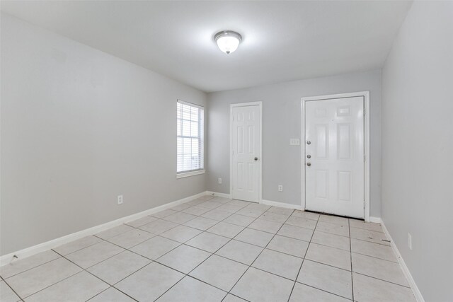 4934 S Cancun Dr, Houston, TX 77045 - unfurnished room with baseboards and light tile patterned floors