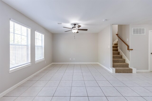 4934 S Cancun Dr, Houston, TX 77045 - empty room with stairway, ceiling fan, visible vents, and light tile patterned floors