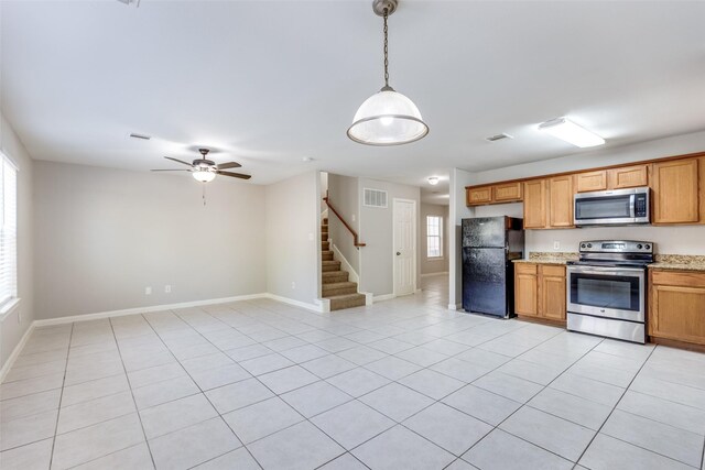 4934 S Cancun Dr, Houston, TX 77045 - kitchen featuring stainless steel appliances, visible vents, a ceiling fan, decorative light fixtures, and light tile patterned floors