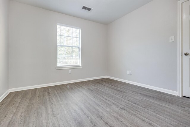4934 S Cancun Dr, Houston, TX 77045 - spare room featuring wood finished floors, visible vents, and baseboards