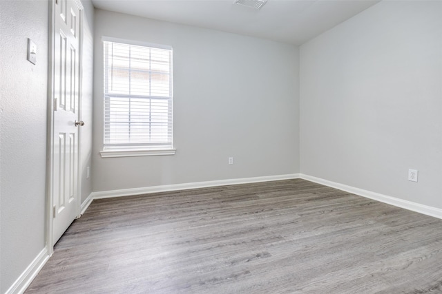 4934 S Cancun Dr, Houston, TX 77045 - empty room with wood finished floors, visible vents, and baseboards