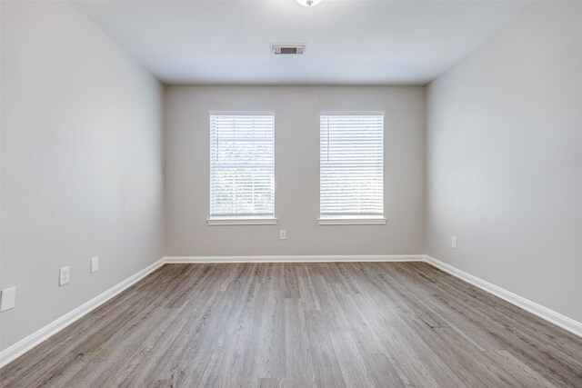 4934 S Cancun Dr, Houston, TX 77045 - empty room featuring wood finished floors, visible vents, and baseboards