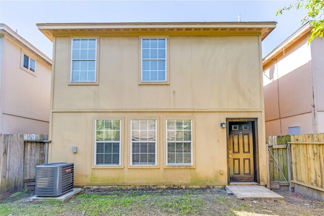 4934 S Cancun Dr, Houston, TX 77045 - rear view of property with fence, a gate, central AC, and stucco siding
