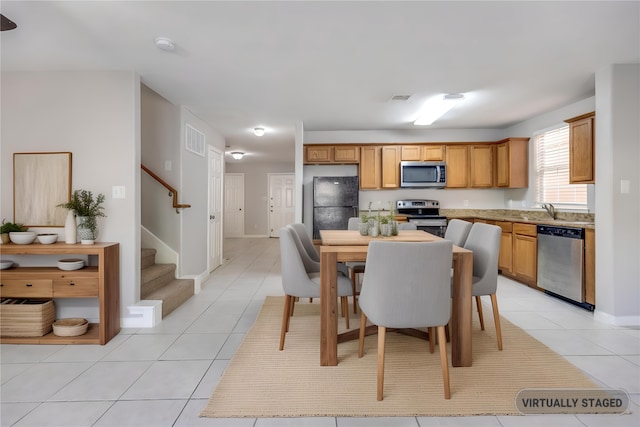 4934 S Cancun Dr, Houston, TX 77045 - dining space featuring stairway, visible vents, and light tile patterned floors