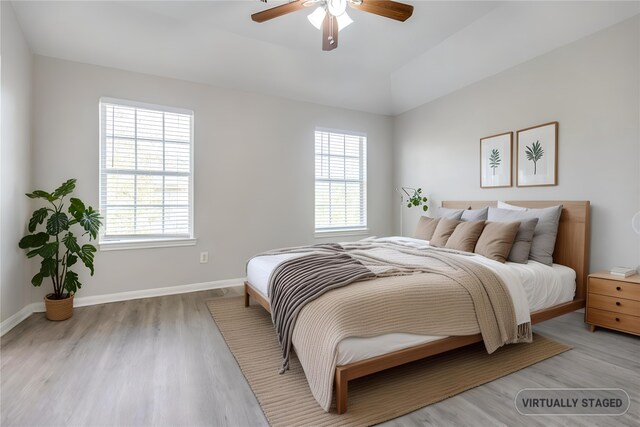4934 S Cancun Dr, Houston, TX 77045 - bedroom with baseboards, a ceiling fan, wood finished floors, and multiple windows