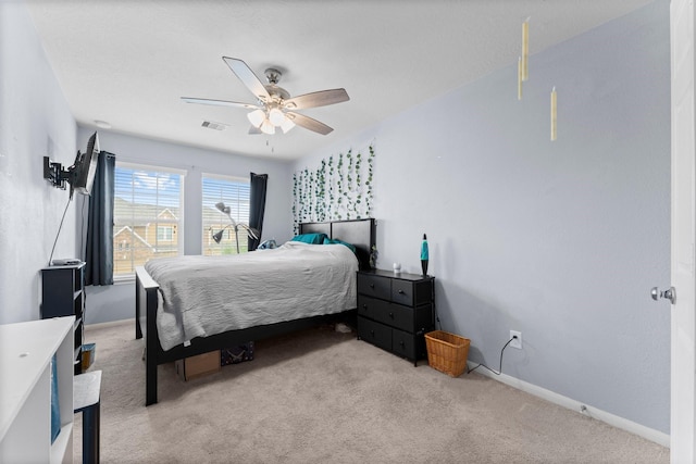 carpeted bedroom with baseboards, visible vents, and ceiling fan