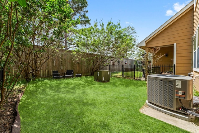 view of yard featuring a fenced backyard and central AC unit