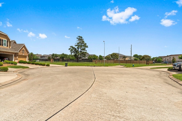 view of road with a residential view and curbs