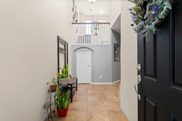 foyer with baseboards and light tile patterned floors