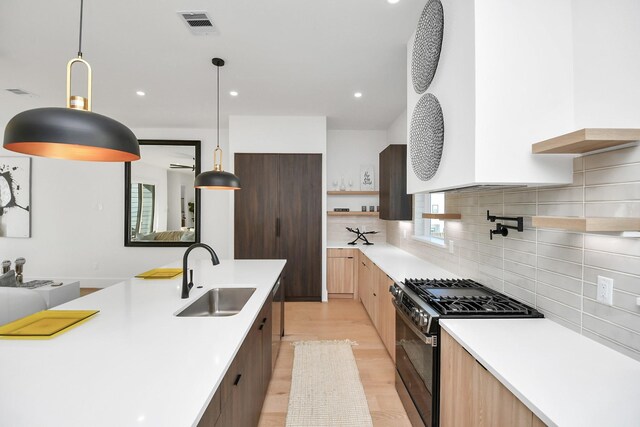 315 N Nagle St, Houston, TX 77003 - kitchen with a sink, modern cabinets, open shelves, light countertops, and appliances with stainless steel finishes