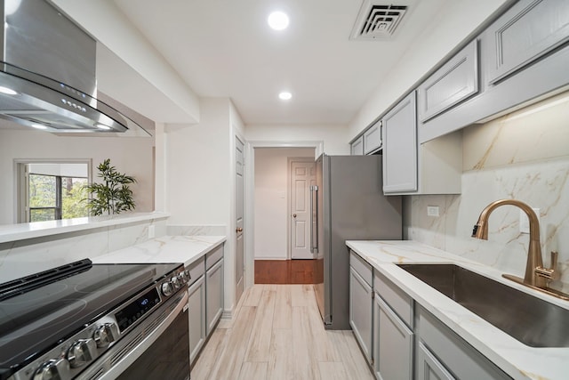 661 Bering Dr Unit 301, Houston, TX 77057 - kitchen with appliances with stainless steel finishes, gray cabinets, wall chimney exhaust hood, and recessed lighting