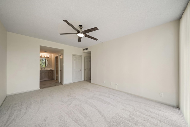 661 Bering Dr Unit 301, Houston, TX 77057 - unfurnished bedroom featuring light colored carpet, ensuite bath, ceiling fan, and baseboards