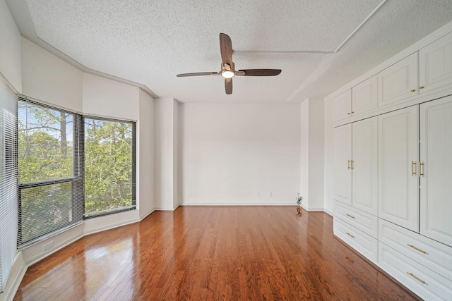 661 Bering Dr Unit 301, Houston, TX 77057 - unfurnished bedroom with wood finished floors, a textured ceiling, a ceiling fan, baseboards, and a closet