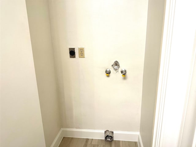 661 Bering Dr Unit 301, Houston, TX 77057 - laundry room featuring electric dryer hookup, baseboards, and wood finished floors