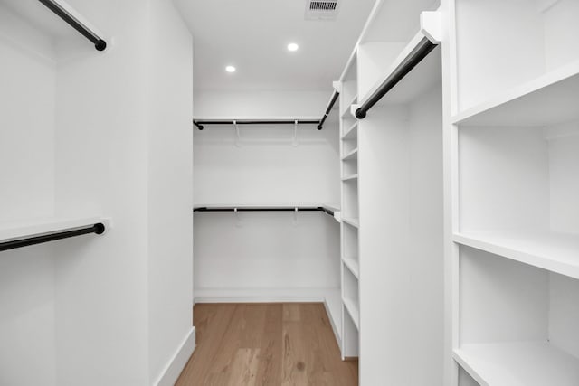 walk in closet featuring light wood-type flooring and visible vents