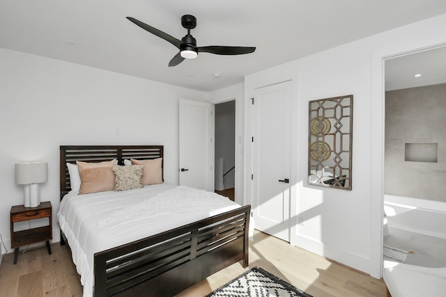 bedroom with a closet, baseboards, a ceiling fan, and light wood-type flooring