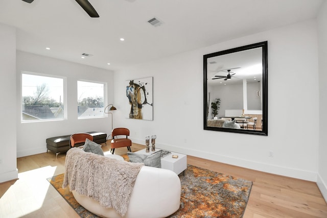 living area with wood finished floors, visible vents, recessed lighting, and ceiling fan
