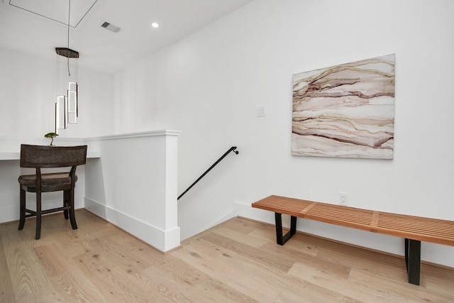 interior space featuring recessed lighting, visible vents, an upstairs landing, light wood-style floors, and attic access