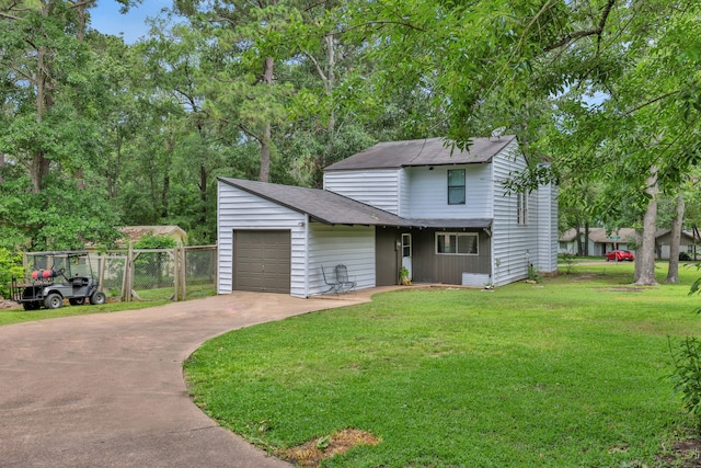 view of front of house with fence, a front yard, a shingled roof, an attached garage, and driveway
