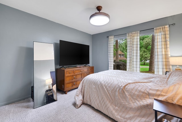 carpeted bedroom with baseboards