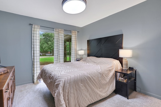 carpeted bedroom featuring baseboards