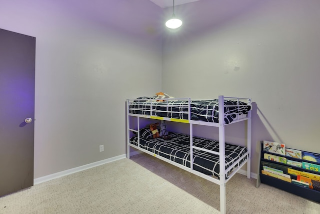 bedroom with baseboards and carpet