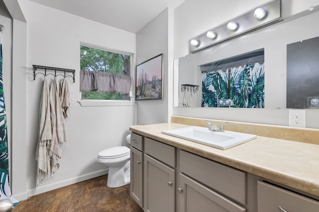 full bath with vanity, baseboards, and toilet