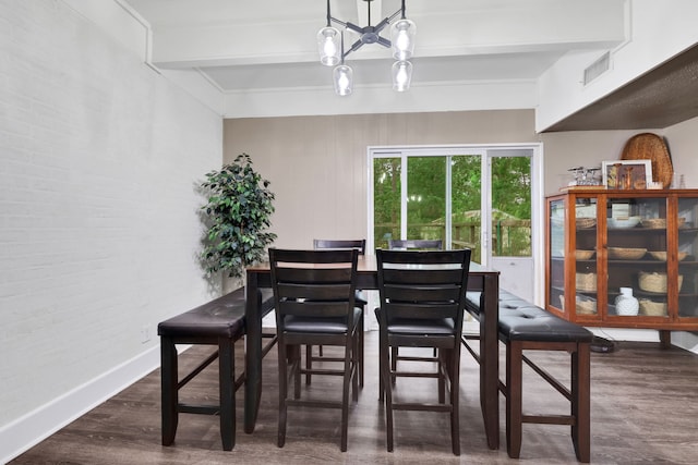 dining room featuring visible vents, wood finished floors, baseboards, beamed ceiling, and a notable chandelier