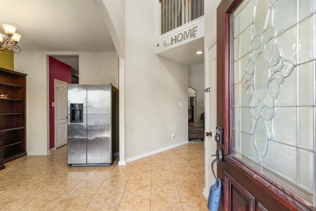 13207 Davenport Hills Ln, Humble, TX 77346 - entrance foyer featuring light tile patterned floors, arched walkways, and baseboards