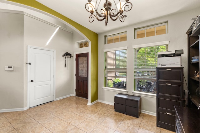 13207 Davenport Hills Ln, Humble, TX 77346 - foyer entrance featuring arched walkways, baseboards, a chandelier, and light tile patterned flooring