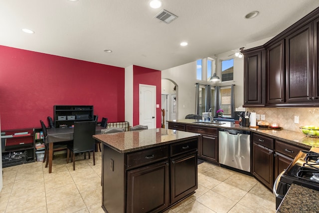 13207 Davenport Hills Ln, Humble, TX 77346 - kitchen with stainless steel dishwasher, arched walkways, light tile patterned flooring, and a sink