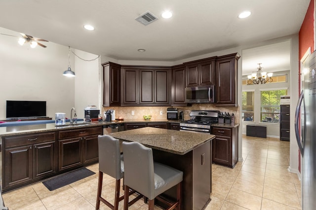 13207 Davenport Hills Ln, Humble, TX 77346 - kitchen with a sink, backsplash, stainless steel appliances, and visible vents
