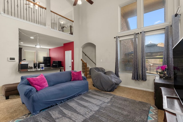 13207 Davenport Hills Ln, Humble, TX 77346 - living area featuring baseboards, arched walkways, a high ceiling, and ceiling fan