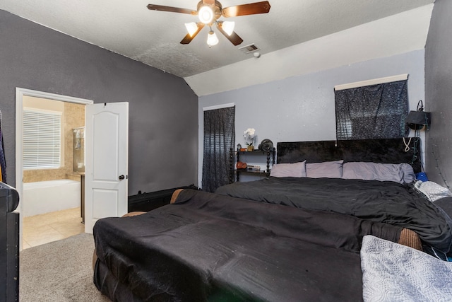 13207 Davenport Hills Ln, Humble, TX 77346 - bedroom featuring tile patterned flooring, a ceiling fan, vaulted ceiling, and ensuite bath