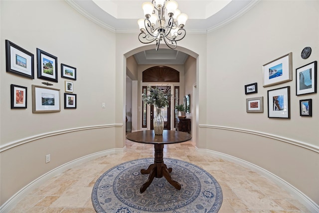 interior space featuring arched walkways, stone tile floors, baseboards, and an inviting chandelier