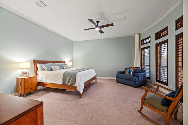 carpeted bedroom featuring visible vents, a ceiling fan, baseboards, and ornamental molding
