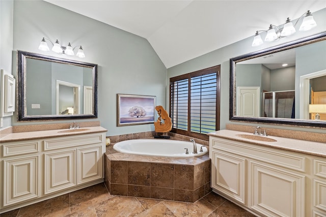 full bathroom with lofted ceiling, a garden tub, a stall shower, and a sink
