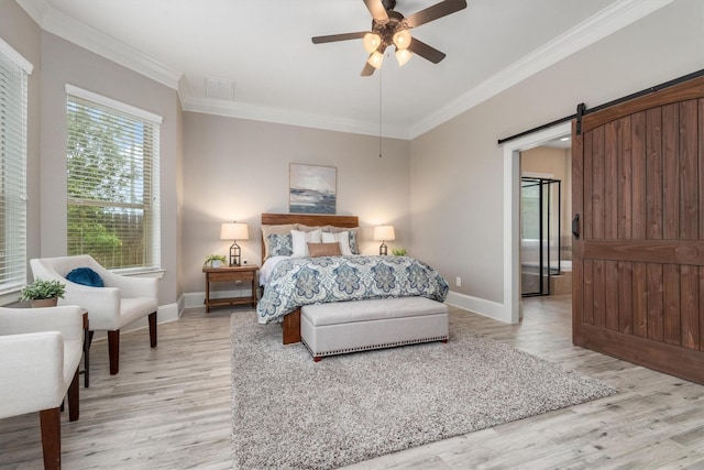 bedroom featuring light wood finished floors, baseboards, and crown molding