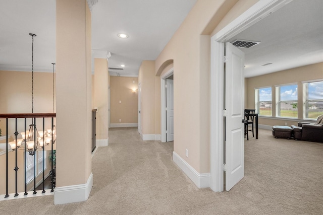 hallway with baseboards, visible vents, and carpet floors