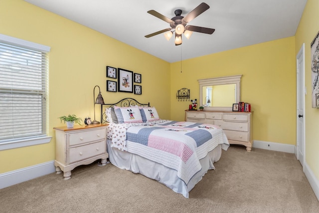bedroom featuring a ceiling fan, baseboards, and light colored carpet
