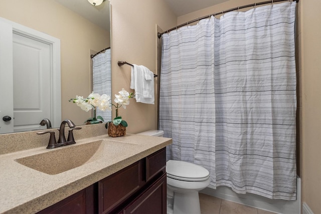 bathroom featuring vanity, toilet, tile patterned flooring, and shower / bath combo