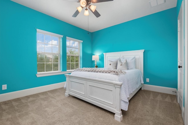 bedroom featuring baseboards, visible vents, carpet floors, and ceiling fan
